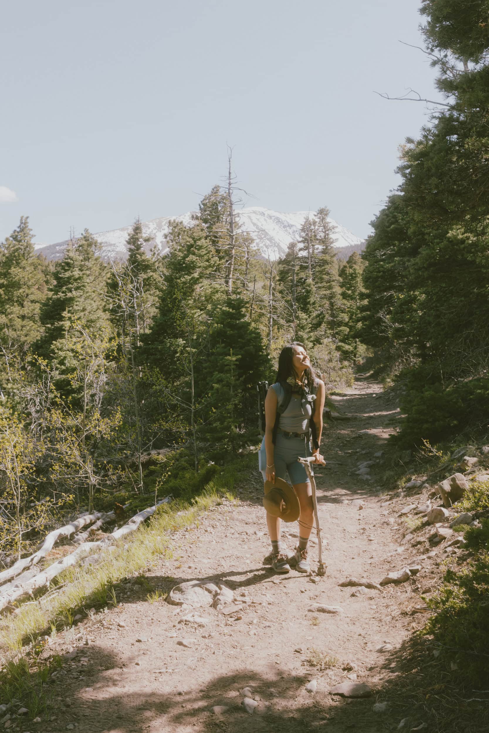A girl named Jessy hiking and smiling on a trail in Westcliffe, Colorado by Our World with Jessy